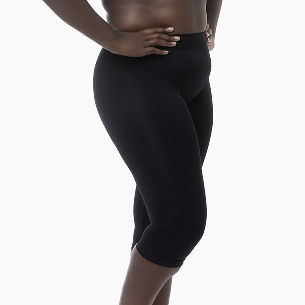 Person wearing black leggings on a white background