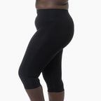 Black capri leggings worn by a person on a white background