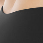 Close-up of a person wearing a black garment with a blurred background