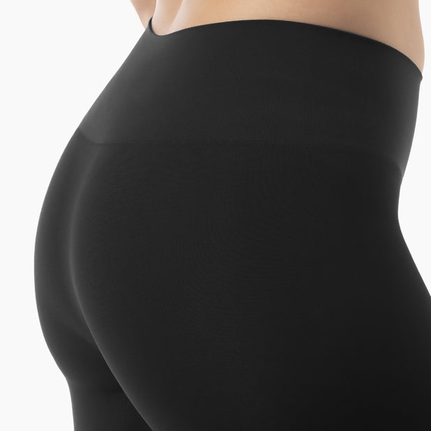 Black leggings worn by a person on a white background