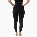 Person wearing black leggings on a white background