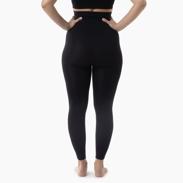 Person wearing black leggings on a white background