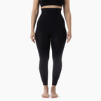 Person wearing black leggings on a white background