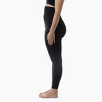 Person wearing black leggings on a white background