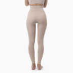 Beige leggings worn by a person on a white background