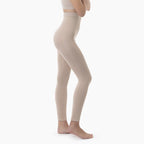 Beige leggings worn by a person on a white background
