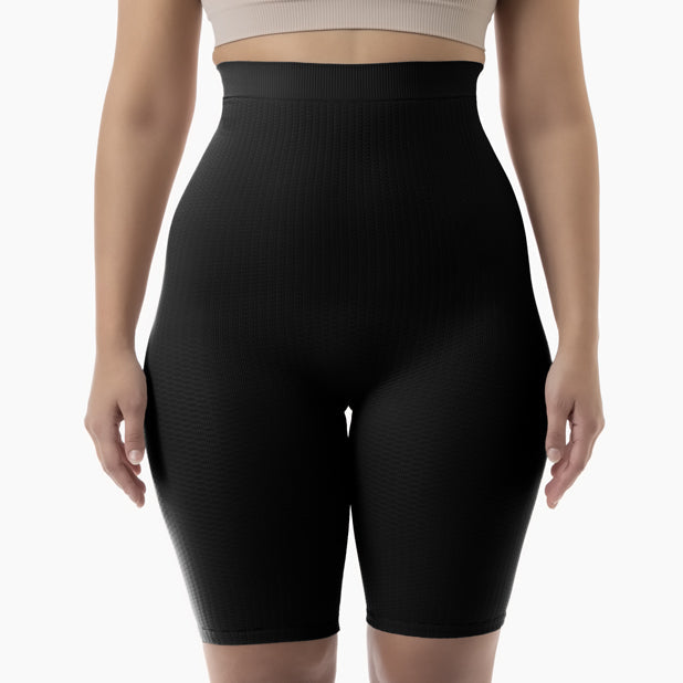 Black high-waisted shorts worn by a person on a white background