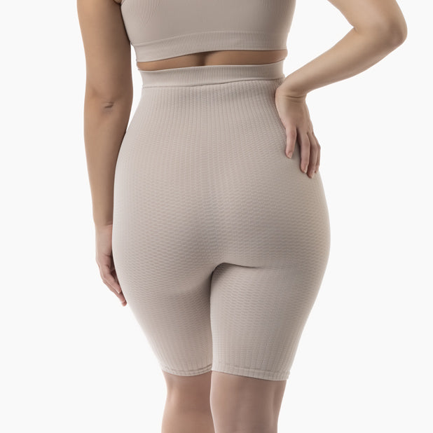 Beige ribbed shorts worn by a person on a white background