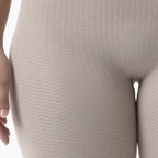 Close-up of beige textured leggings on a white background