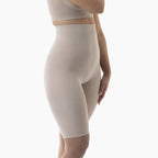 Beige compression shorts worn by a person on a white background