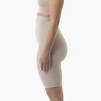 Beige shapewear garment worn by a person on a white background