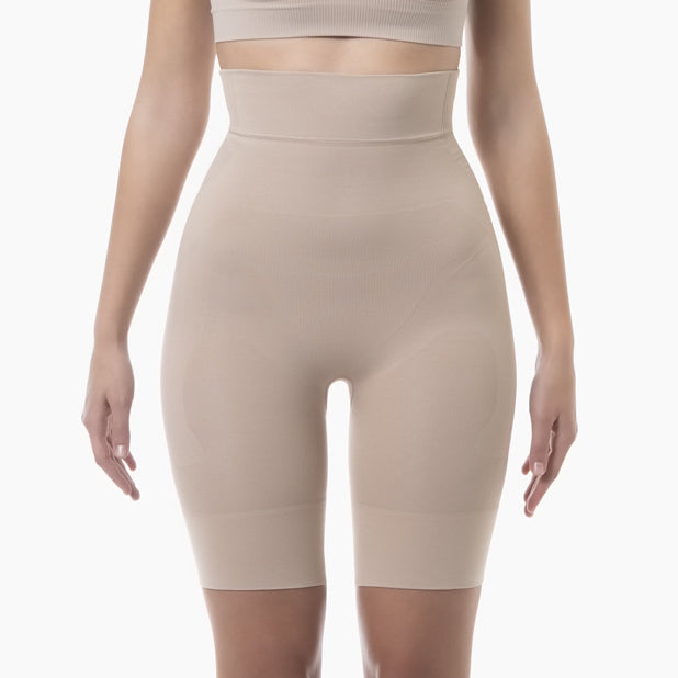 Beige shapewear shorts worn by a person on a white background