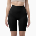 Black high-waisted shapewear shorts worn by a person on a white background