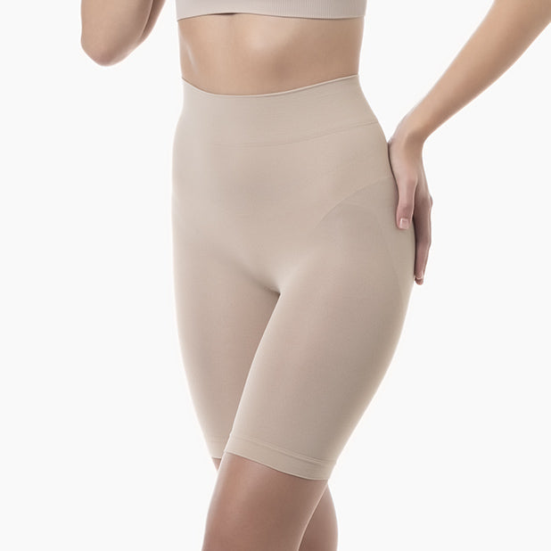 Beige high-waisted shorts worn by a person on a white background