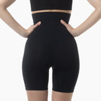 Black high-waisted shapewear shorts on a white background