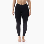 Person wearing black leggings on a white background