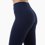 Navy blue leggings with a textured pattern on a white background