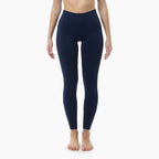 Person wearing navy blue leggings on a white background