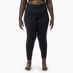 Person wearing black leggings on a white background