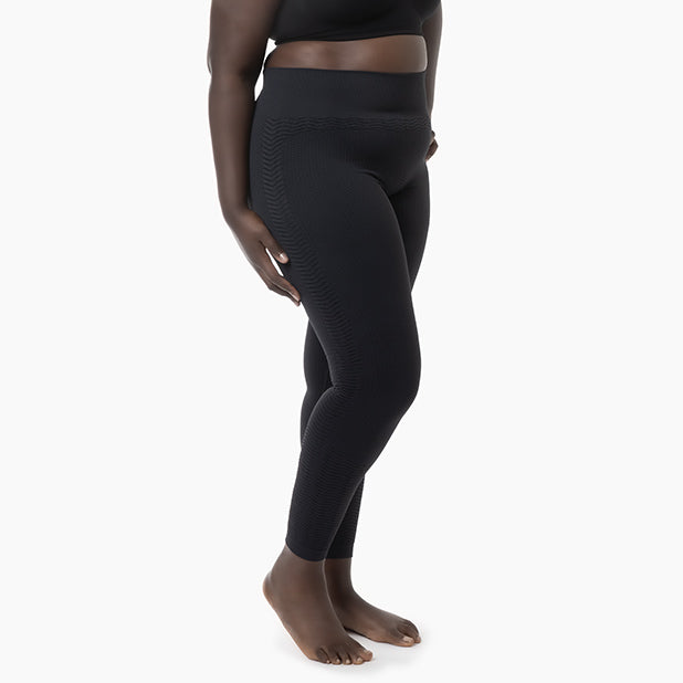 Person wearing black leggings on a white background