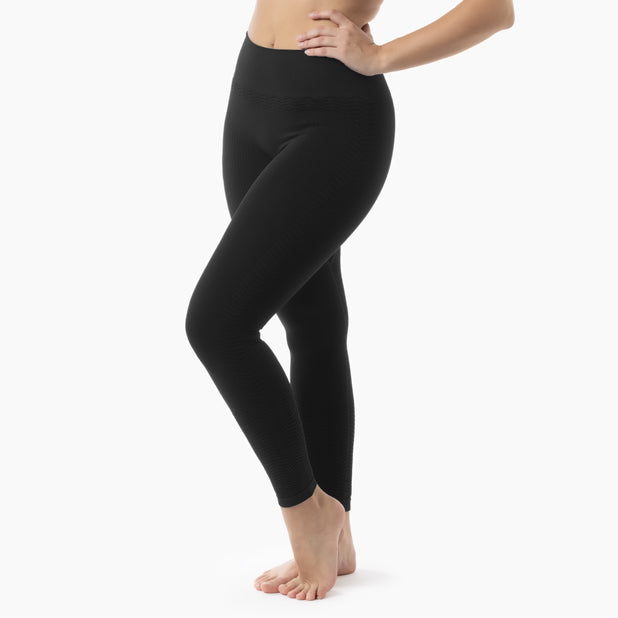 Person wearing black leggings on a white background