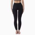 Person wearing black leggings on a white background