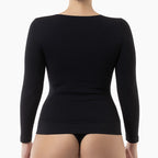 Black long-sleeve top worn by a person on a white background