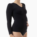 Black long-sleeve top worn by a person on a white background