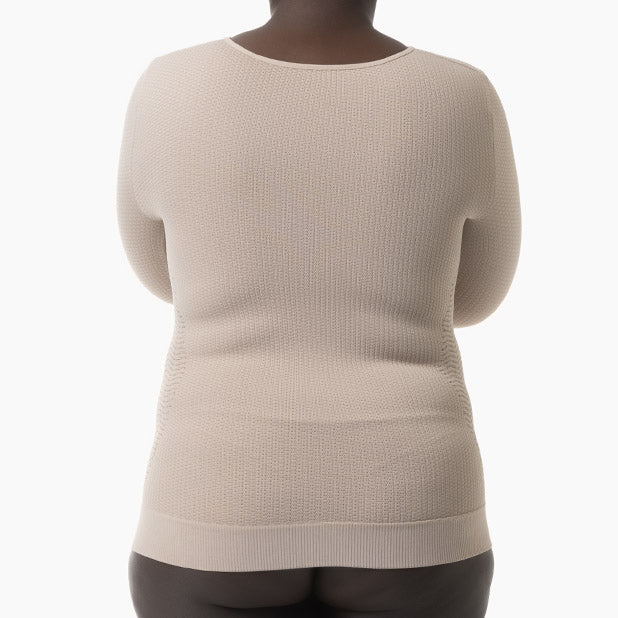 Beige sweater worn by a person on a white background