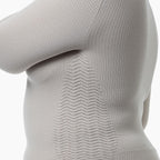 Close-up of a gray textured sweater on a white background