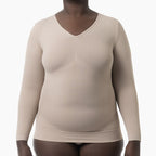 Beige long-sleeve shirt worn by a person on a white background