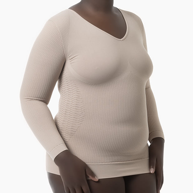 Beige long-sleeve top worn by a model on a white background