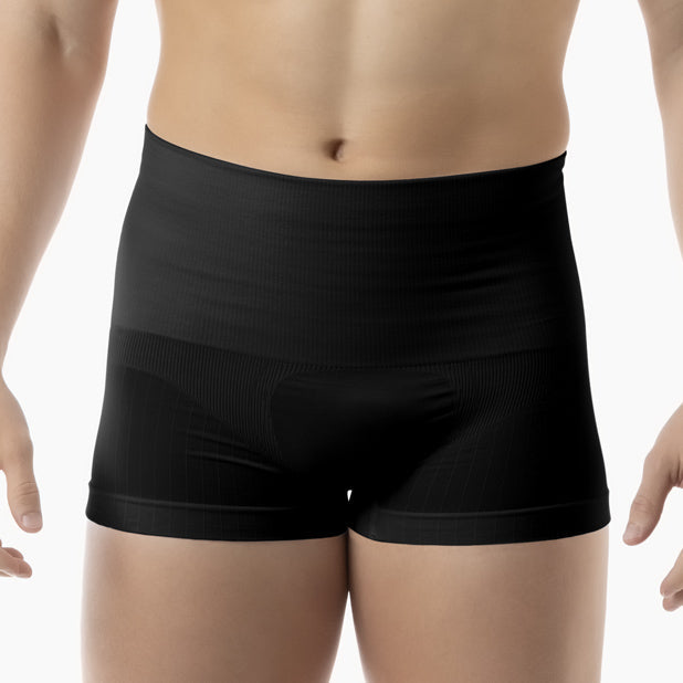 Black boxer briefs worn by a person on a white background