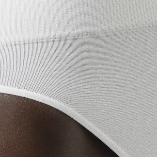 Close-up of a white athletic shirt with a ribbed neckline on a dark background