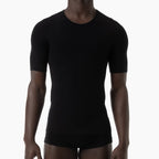 Person wearing a black t-shirt and underwear set on a white background
