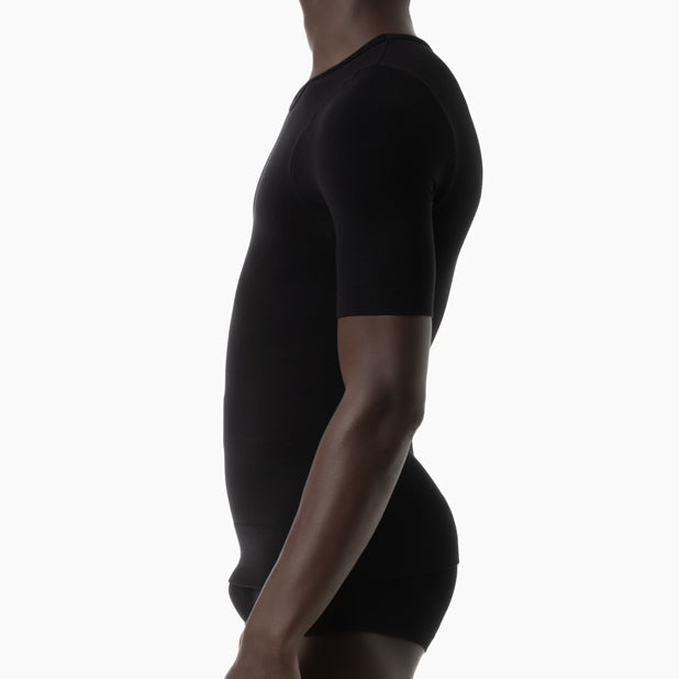 Person wearing a black t-shirt and shorts on a white background