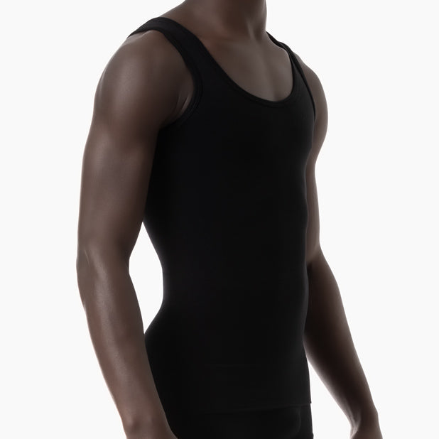 Person wearing a black tank top on a white background