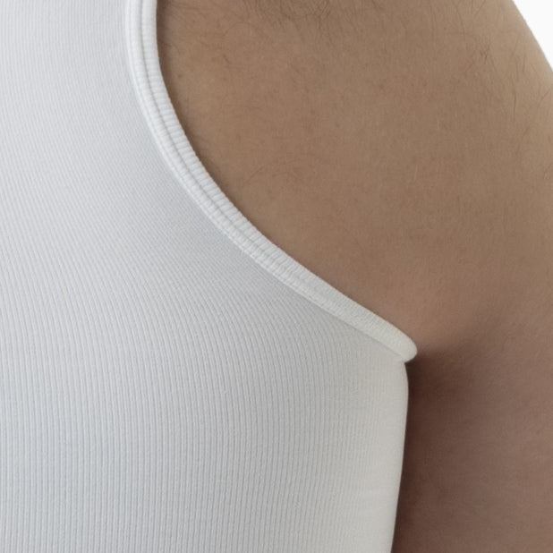 Close-up of a white tank top on a person's shoulder