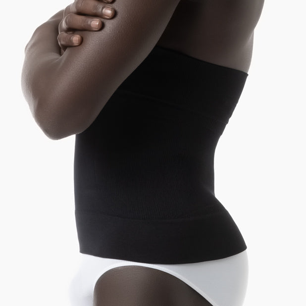 Black compression garment worn by a person on a white background