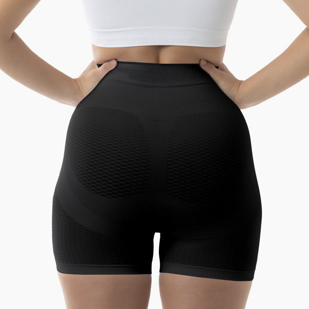 Black high-waisted shorts worn by a person on a white background