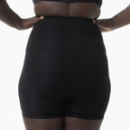 Black shapewear worn by a person on a white background
