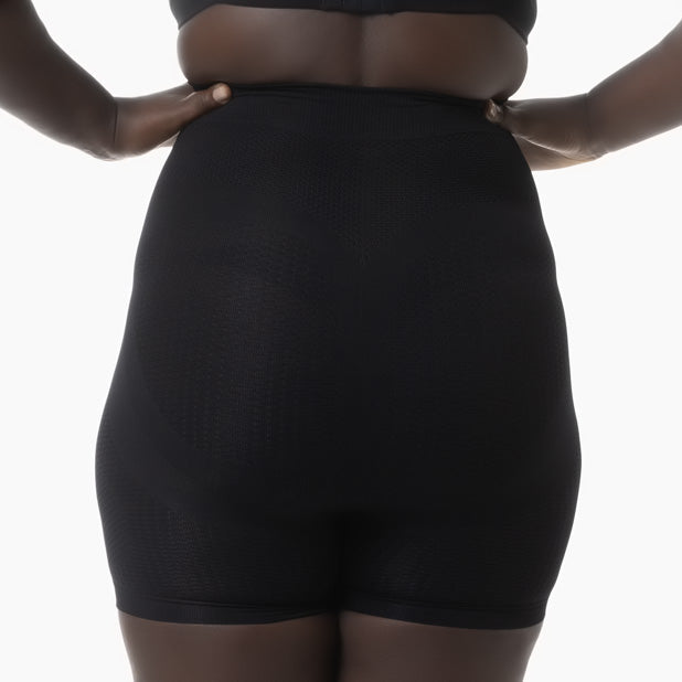 Black shapewear worn by a person on a white background