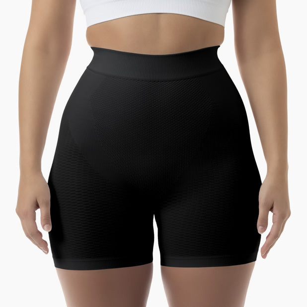 Black high-waisted shorts worn by a person on a white background