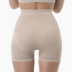 Beige shapewear shorts worn by a person on a white background