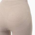 Close-up of beige shapewear on a mannequin with a white background