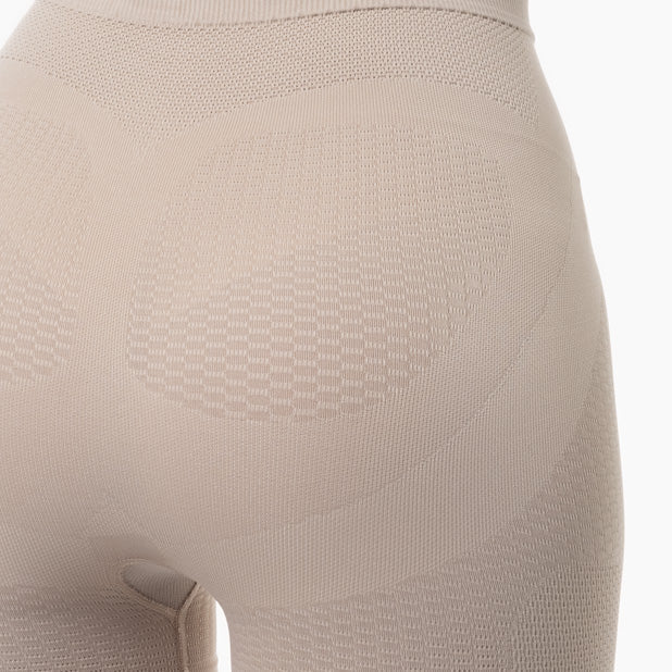 Close-up of beige shapewear on a mannequin with a white background