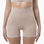 Beige shapewear shorts worn by a person on a white background