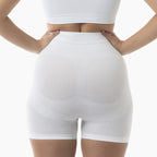 White shapewear shorts worn by a person on a white background