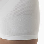 Close-up of a textured white garment on a neutral background