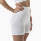 White compression shorts worn by a person on a white background